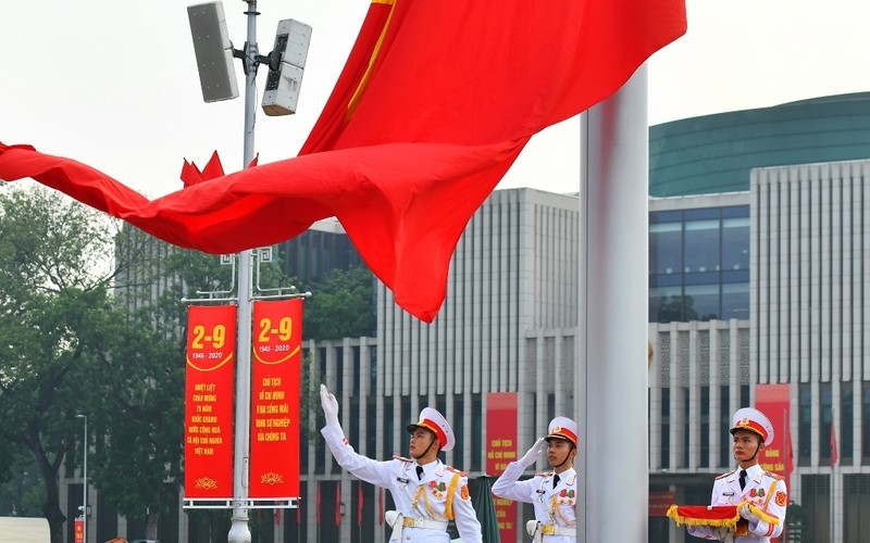 The national flag flying surrounded by the music of the national anthem at Ba Dinh Square.