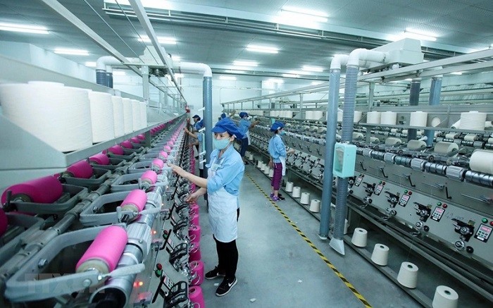 Workers operating a production line at the Jasan Textile & Dyeing (Vietnam) Co.,Ltd.