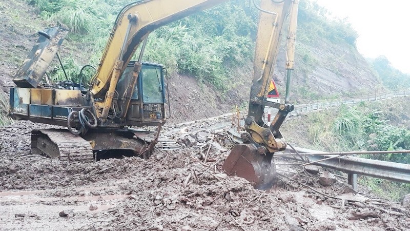 A road was being cleared to reach the landslide site.