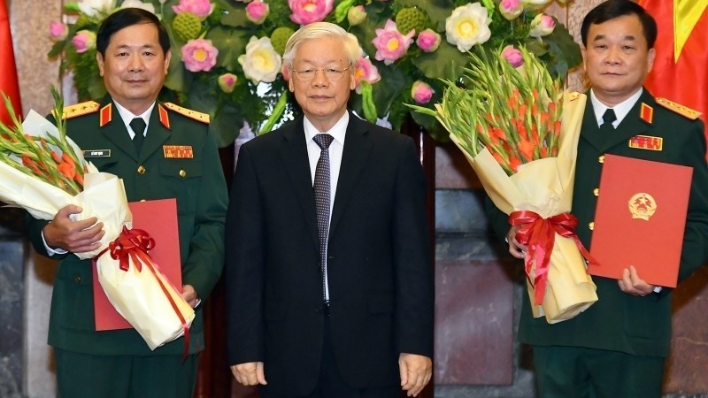 Party General Secretary and President Nguyen Phu Trong (C) hands over the promotion decisions to Senior Lieutenant General Hoang Xuan Chien and Senior Lieutenant General Le Huy Vinh.
