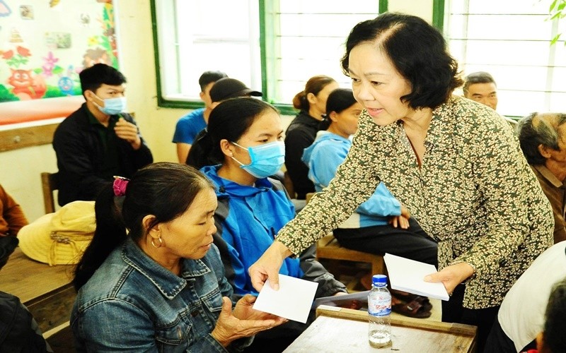 Chairwoman of the Party Central Committee’s Commission for Mass Mobilisation Truong Thi Mai presents gifts to local people in Cam Tuyen commune, Cam Lo district. (Photo: NDO)