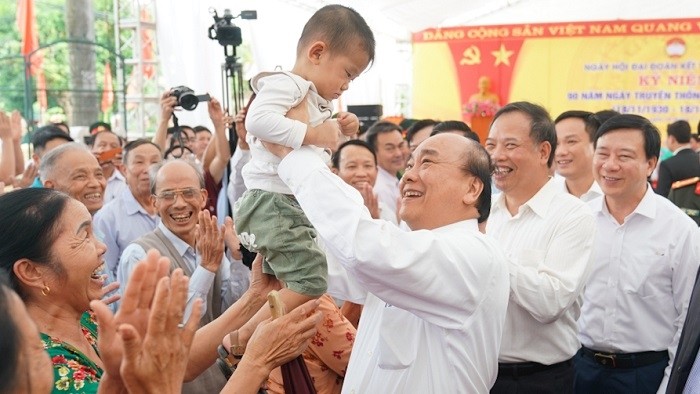 Prime Minister Nguyen Xuan Phuc holds a child while joining people in the great national solidarity festival in Hai Duong province on November 18, 2020. (Photo: VGP)