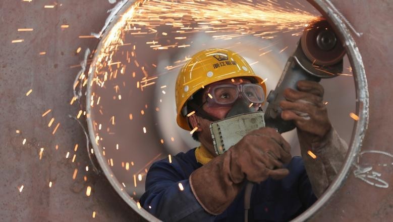 An employee works on a production line manufacturing steel structures at a factory in Huzhou, Zhejiang province, China May 17, 2020. (Photo: Reuters)