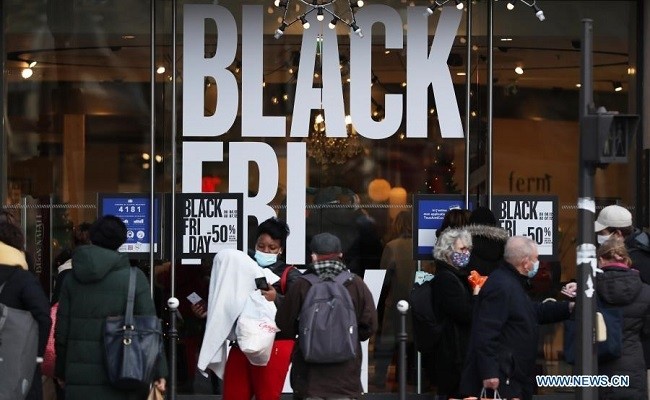 People walk past posters about "Black Friday" in Paris, France, Dec. 4, 2020. Postponed a week due to the national lockdown, the annual "Black Friday" started on Friday. (Photo: Xinhua)