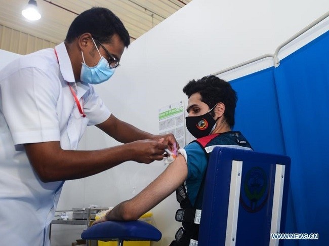 A frontline medical worker receives a COVID-19 vaccine at the vaccination center in Hawalli Governorate, Kuwait, Dec. 24, 2020. Kuwait launched on Thursday the national vaccination campaign against the COVID-19. (Photo: Xinhua)