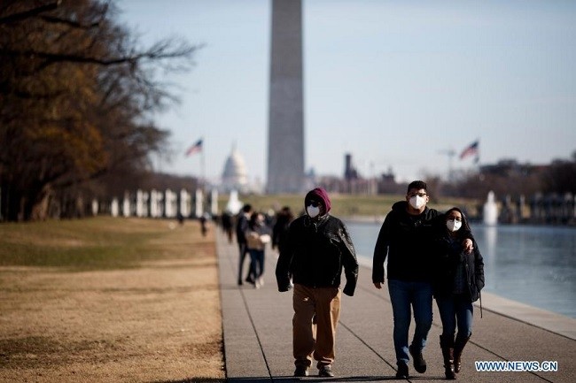 People wearing masks walk at the National Mall in Washington, D.C., the United States, on Dec. 27, 2020. (Photo: Xinhua)