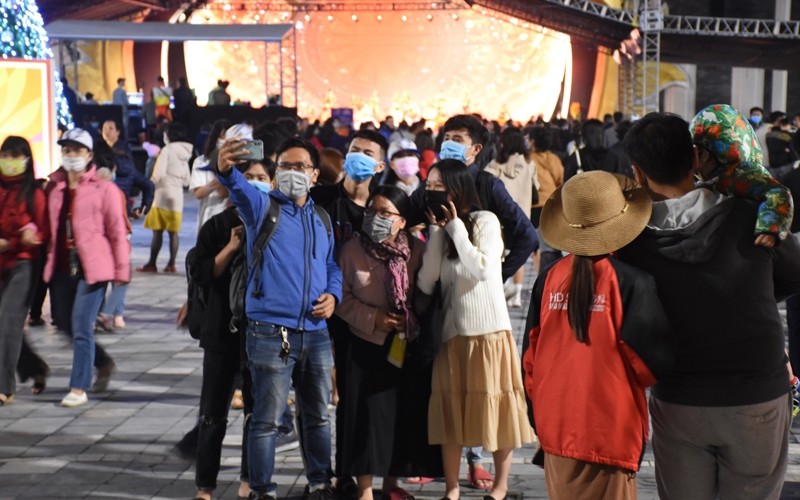 Local people and visitors wearing face masks to enjoy the festive atmosphere 