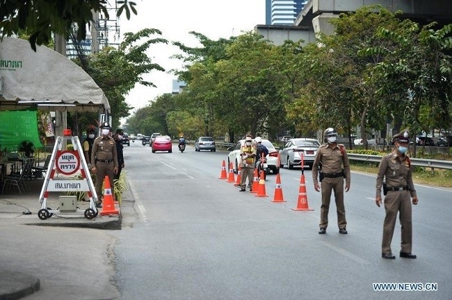 Policemen work at a check point of body temperature in Bangkok, Thailand, Jan. 5, 2021. The Center for the COVID-19 Situation Administration (CCSA) declared 28 provinces, including the capital Bangkok and surrounding provinces, as areas under maximum control from Jan. 4 to Feb. 1, to stem a further spread of the virus. (Photo: Xinhua)