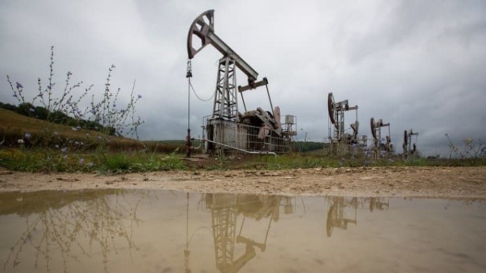 Oil pumping jacks are reflected in a puddle as they operate in an oilfield near Almetyevsk, Russia, on Sunday, Aug. 16, 2020. (Getty Images)