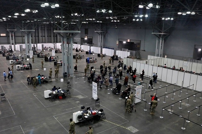 People line up as health care workers and military personnel work to distribute doses of the coronavirus disease vaccine at the New York State Covid-19 vaccination site at the Jacob K. Javits Convention Centre January 13, 2021. (Photo: Reuters)