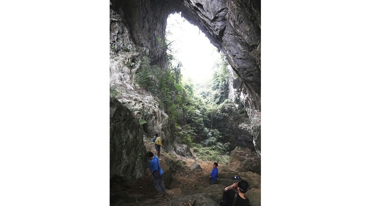Mountaineers taking a rest at the mouth of the cave inside Lung Pang Peak.