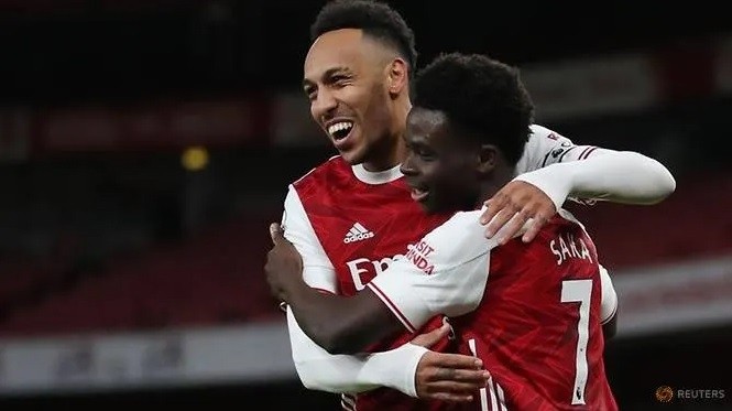 Arsenal's Bukayo Saka celebrates scoring their second goal with Pierre-Emerick Aubameyang. (Reuters)