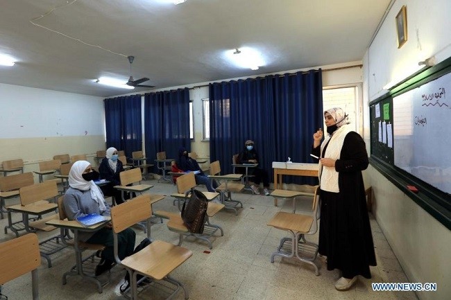 Students wearing face masks attend a class at a school in Amman, Jordan, on Feb. 8, 2021. Jordanian Ministry of Education gradually resumed in-class education. (Photo: Xinhua) 
