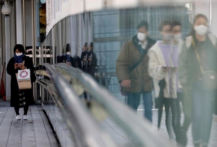FILE PHOTO: Pedestrians wearing protective masks amid the COVID-19 outbreak, walk on a street in Tokyo, Japan, February 2, 2021. (Reuters)