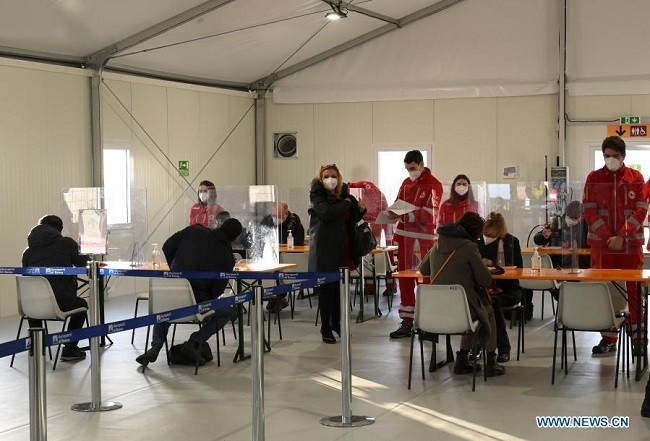 People fill out forms before receiving the COVID-19 vaccine at a vaccination center at Rome's Fiumicino Airport, Italy, on Feb. 11, 2021. (Photo: Xinhua)