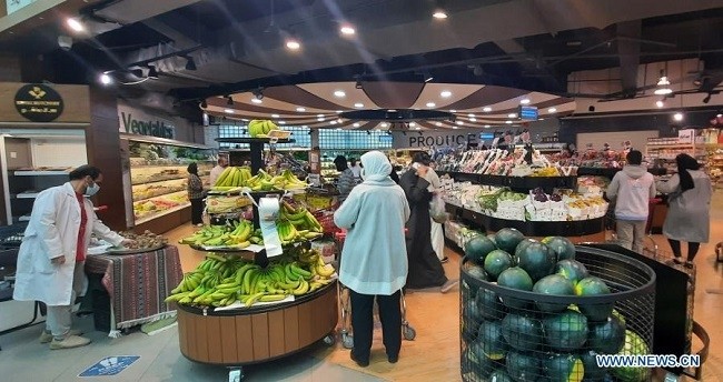 People wearing face masks shop at a supermarket in Hawalli Governorate, Kuwait, March 4, 2021. (Photo: Xinhua)
