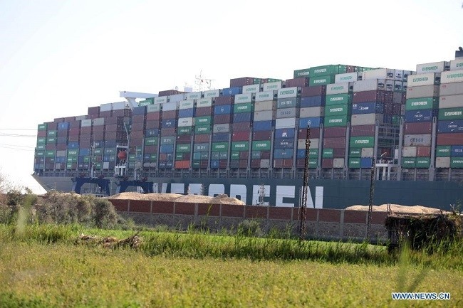 Photo taken on March 27, 2021 shows the stuck container ship Ever Given on the Suez Canal, Egypt. At least 321 vessels are currently jammed around the Suez Canal awaiting salvage of the giant container ship Ever Given that has been stuck and blocking the vital waterway since Tuesday, Osama Rabie, chairman of the Suez Canal Authority (SCA), said Saturday. (Photo: Xinhua)