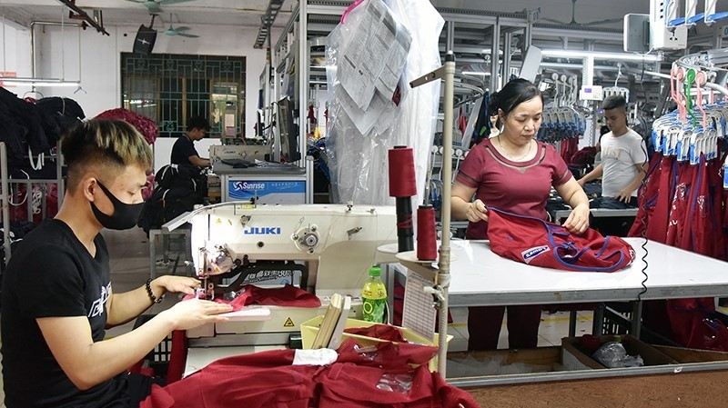 Workers of the Nam Tiep Joint Stock Company, in An Xa Industrial Cluster, Nam Dinh city, Nam Dinh Province, sew clothes for export to Russia, EU and the US. (Photo: NAM ANH)