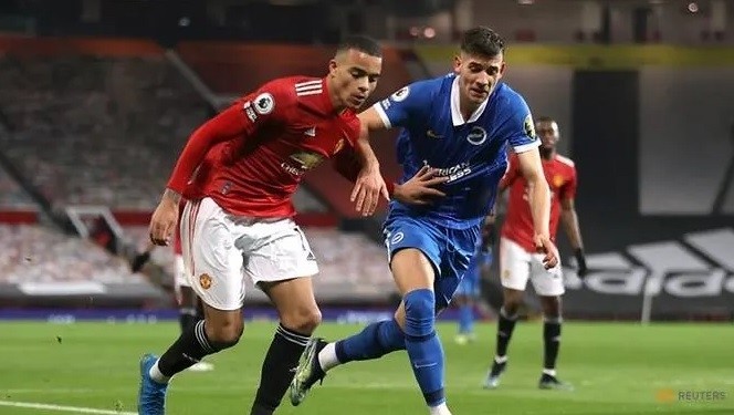 Manchester United's Mason Greenwood in action with Brighton & Hove Albion's Jakub Moder. (Photo: Reuters)