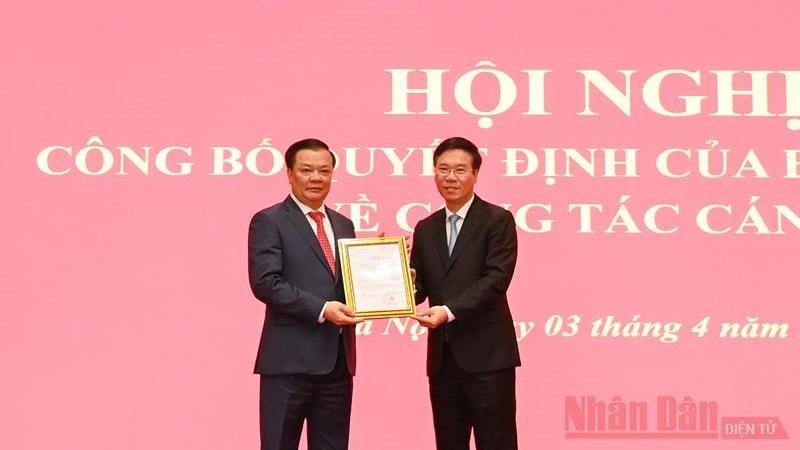 Permanent member of the Party Central Committee's Secretariat Vo Van Thuong grants the Politburo's Decision to Secretary of Hanoi municipal Party Committee Dinh Tien Dung.