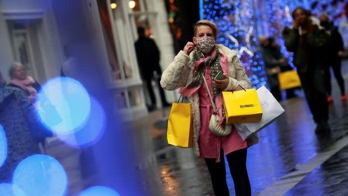 A shopper wearing a face mask walks down the street in London, UK. (Photo: Reuters)