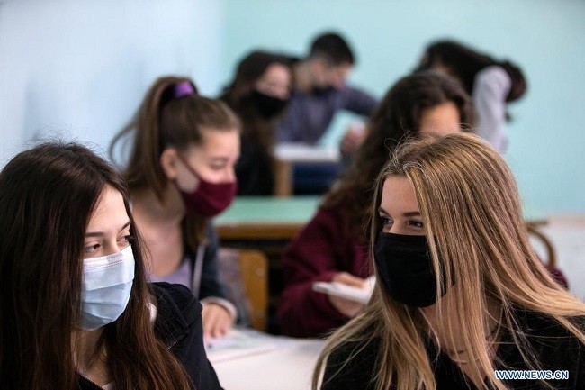 Students wearing face masks are seen in their classroom at a high school in Glyfada, a southern suburb of Athens, Greece, on April 12, 2021. In Greece, high school students returned to classrooms nationwide on Monday after five months of remote learning, although the nationwide lockdown, which started on Nov. 7, 2020, is still in force. (Photo: Xinhua)
