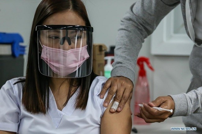 A woman gets inoculated with Sinovac COVID-19 vaccine at a vaccination hub in Taguig City, the Philippines, on April 16, 2021. (Photo: Xinhua)