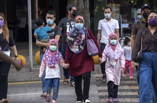 People wearing face masks to prevent the spread of COVID-19 in Kuala Lumpur, Malaysia (Photo: VNA)