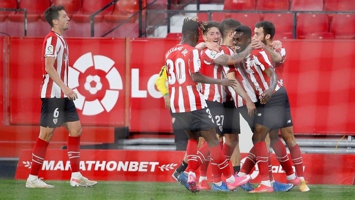 Athletic Bilbao players celebrate after scoring a late goal against Sevilla in La Liga. (Photo: Getty Images)