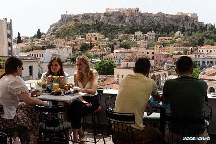 People are seen at a cafe at the foot of the Acropolis, in Athens, Greece, May 3, 2021. Cafeterias, restaurants and bars reopened on Monday across Greece in a festive atmosphere after a six-month shutdown due to the COVID-19 restrictions. The country's second lockdown, which started on Nov. 7, 2020, is gradually being eased this spring, as the number of new infections has stabilized lately and vaccinations continue. (Photo: Xinhua)