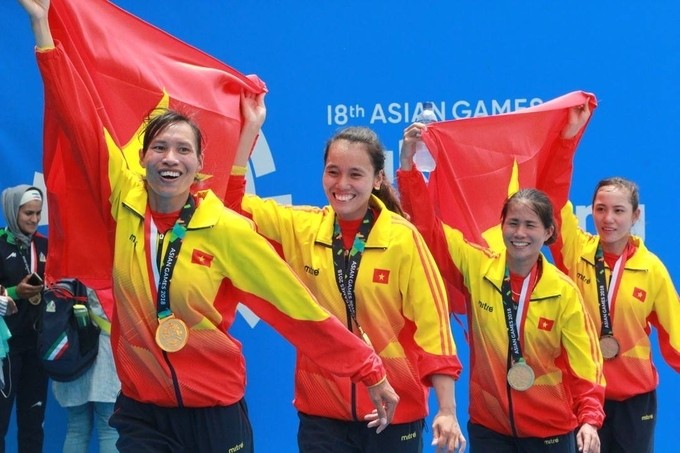 FILE PHOTO: Luong Thi Thao (R) and teammates celebrate winning a gold medal for Vietnamese rowing in the women's lightweight quadruple sculls event at the 2018 Asian Games.  