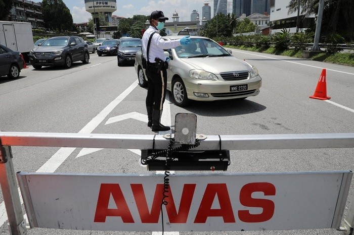 A police officer stands guard at a roadblock during lockdown ahead of the Aidilfitri celebrations in an effort to prevent a large-scale transmission of the coronavirus disease, in Petaling Jaya, Malaysia on Monday, May 10, 2021. (Photo: Reuters)