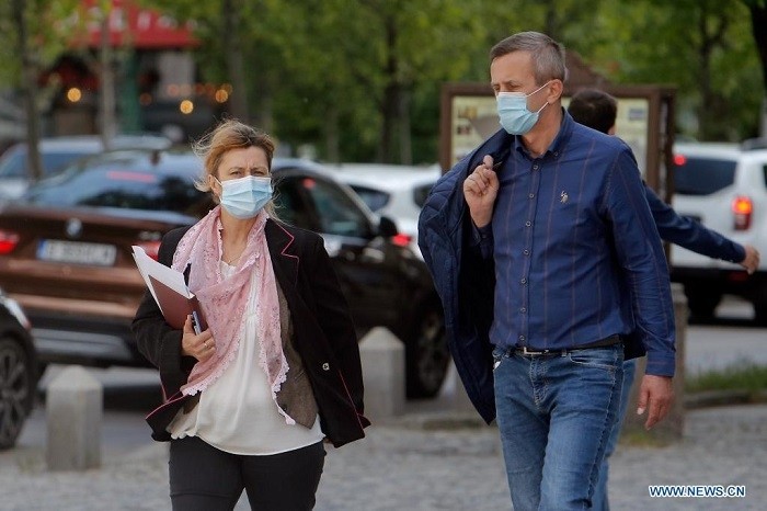 People wearing face masks walk on a street in Bucharest, Romania, on May 14, 2021. Romanian Prime Minister Florin Citu said the government made a decision on Friday to gradually ease the country's coronavirus-related restrictions starting from Saturday. (Photo: Xinhua)