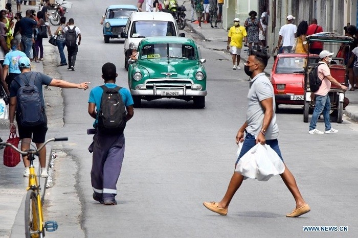 People wearing face masks walk on a street in Havana, Cuba, May 13, 2021. (Photo: Xinhua)