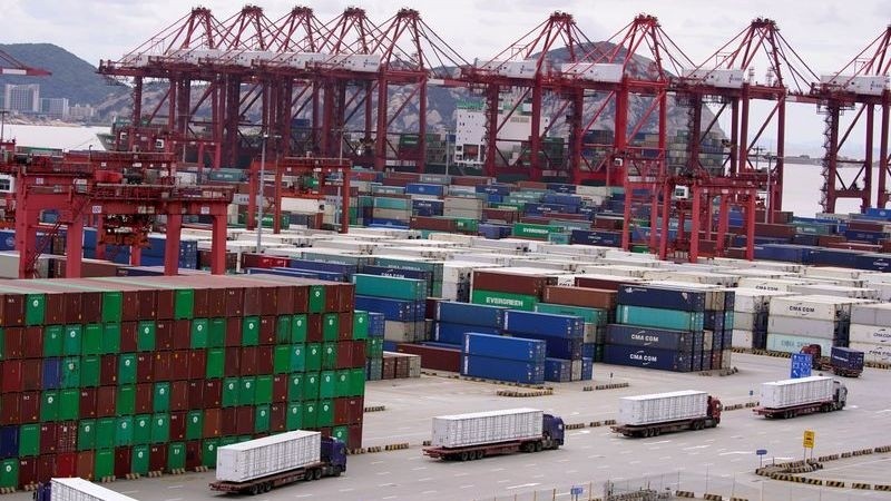 Containers and lorries are seen at the Yangshan Deep Water Port in Shanghai, China, October 19, 2020. (Photo: Reuters)