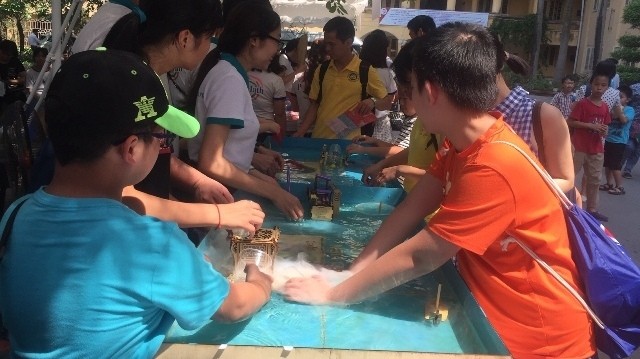 Students conduct a chemistry experiments at a STEM festival.