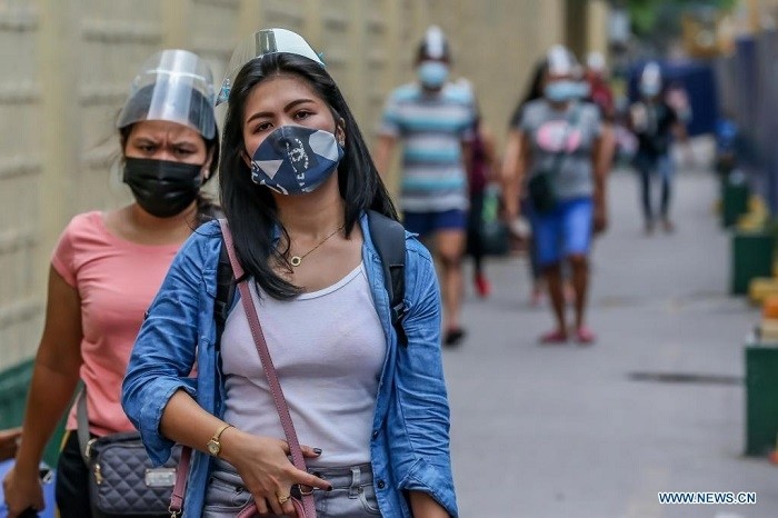 People wearing protective gear walk on a street in Manila, the Philippines, on April 15, 2021. (Photo: Xinhua)