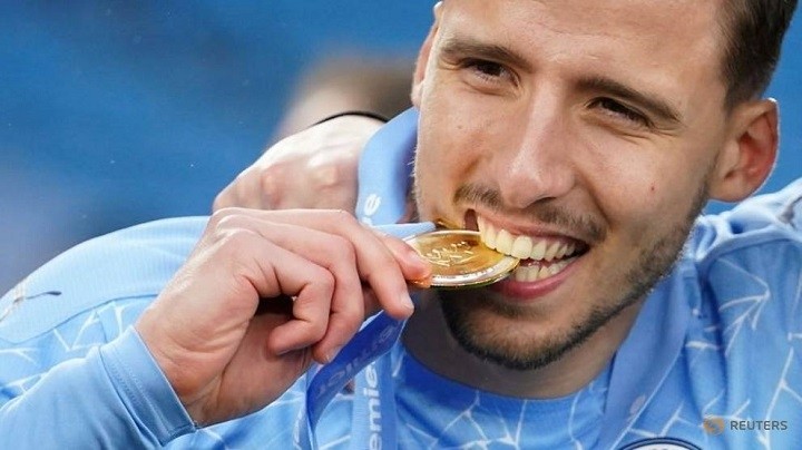 FILE PHOTO: Soccer Football - Premier League - Manchester City v Everton - Etihad Stadium, Manchester, Britain - May 23, 2021 Manchester City's Ruben Dias celebrates with his medal after winning the Premier League. (Photo: Reuters) 