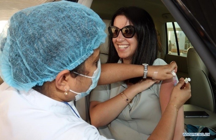 A woman receives a dose of COVID-19 vaccine inside her car at a drive-through vaccination center in Kuwait City, Kuwait, June 10, 2021. (Photo: Xinhua)